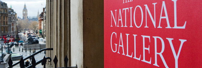 Close-up of red gallery banner, Trafalgar Square in background