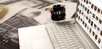 For researchers: laptop, prints and magnifier on a desk