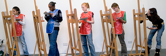 Teenage girls at easles painting in the Learning Gallery
