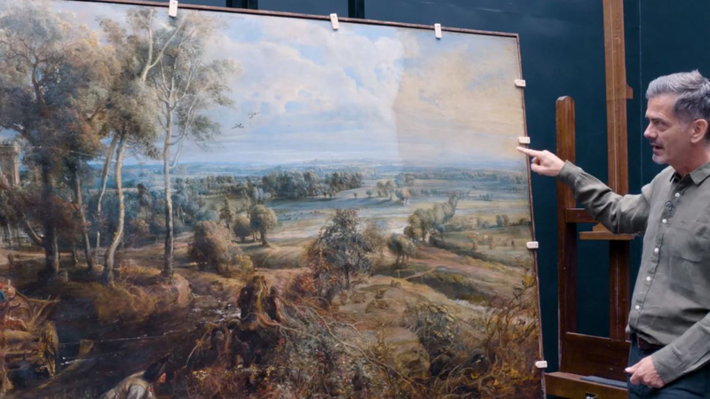 Larry showing the difference in colour where the varnish has been removed (left hand side) and still to be removed (right hand side)